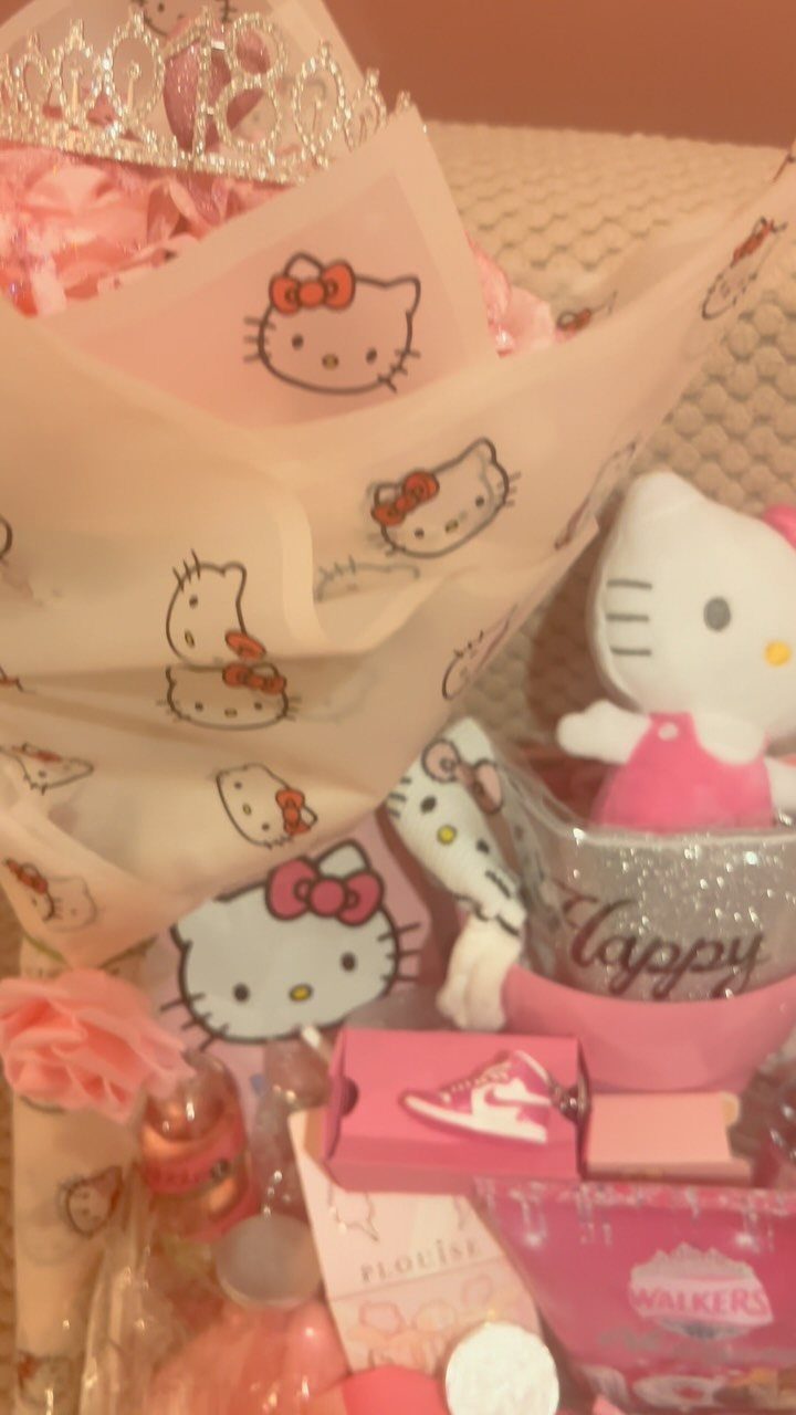 Hello Kitty themed gift basket with pink accessories, plush toy, and silver tiara.