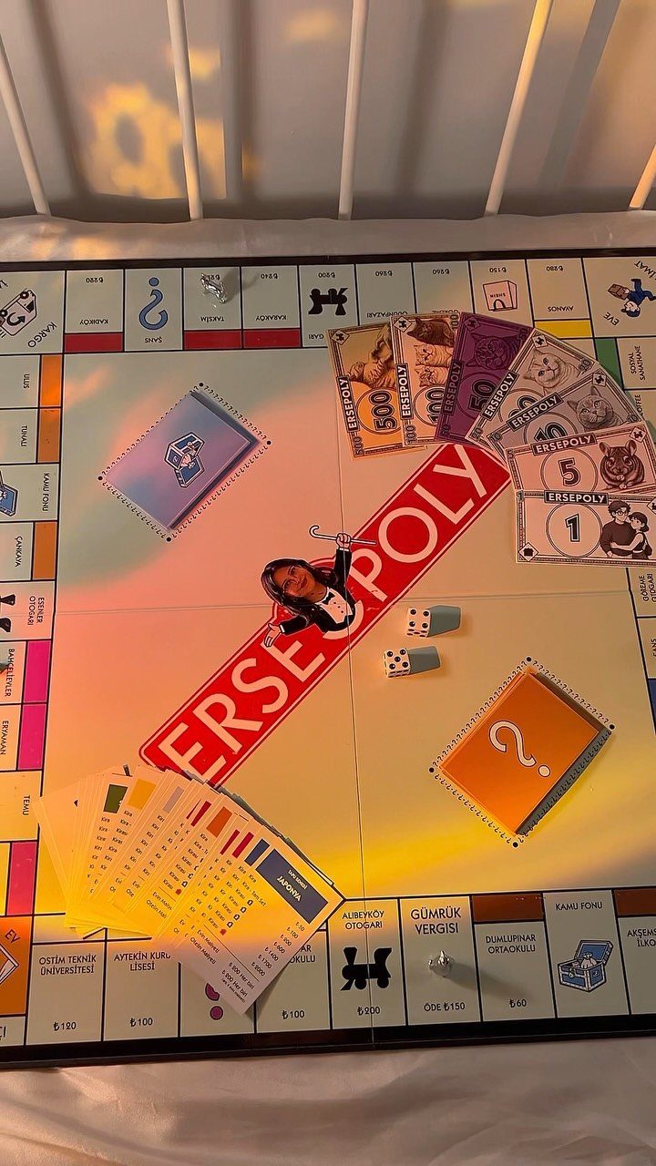 Customized Monopoly board game called Ersepoly with personalized money, cards, and photo piece.
