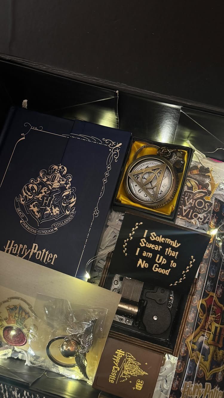 Harry Potter themed gift set in a black box with a book and watch.