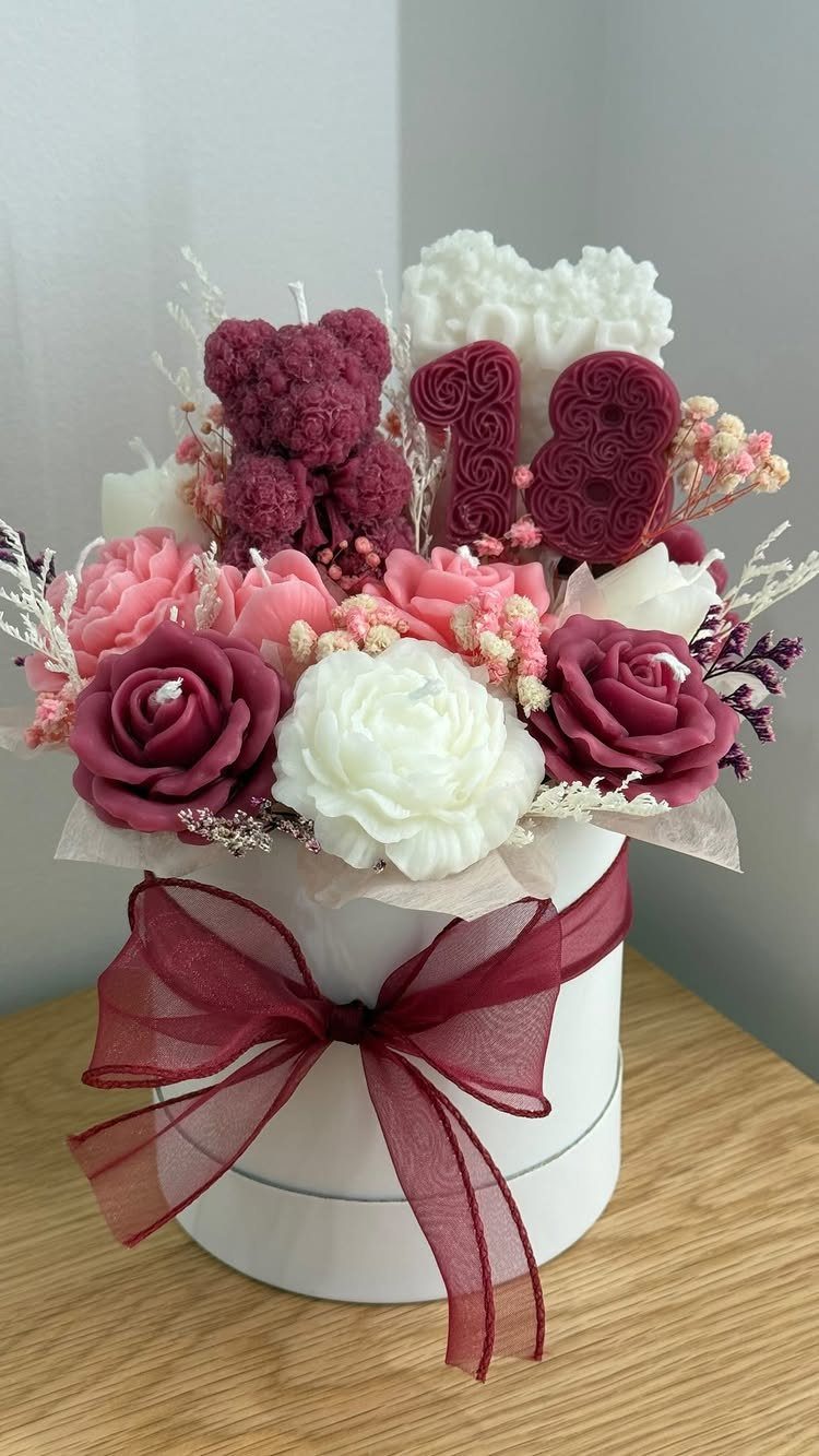Candle bouquet in a white box with roses, a bear, and number 18.