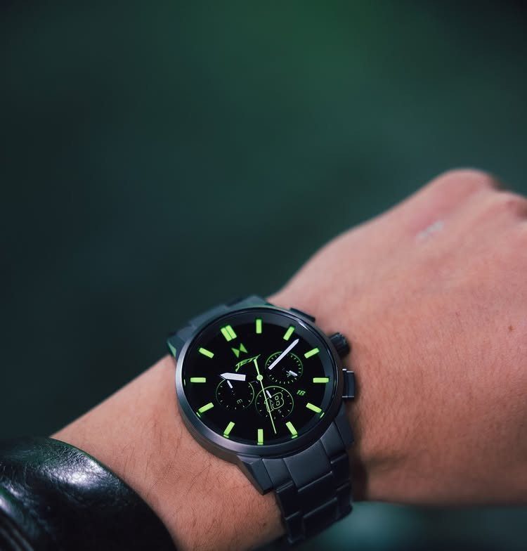 Matte black stylish watch with neon green accents on a person's wrist