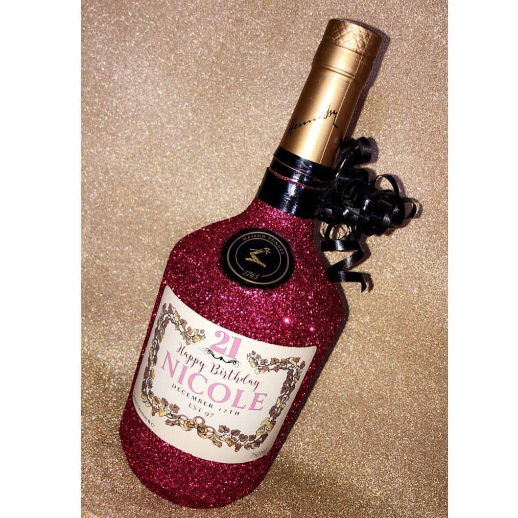 Red glitter wine bottle with a personalized 21st birthday label for Nicole.