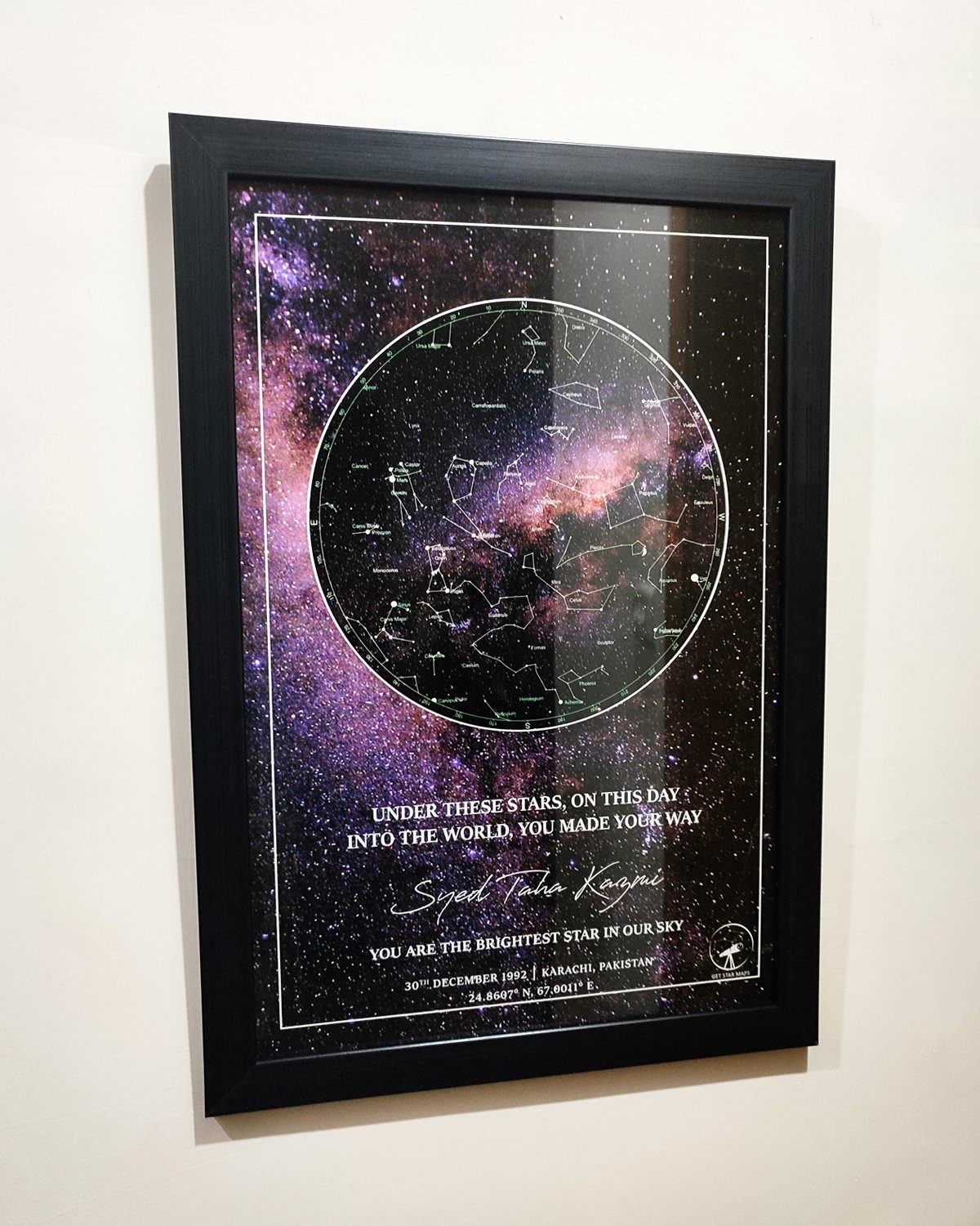 Framed custom star map with a purple nebula background and personalized text.