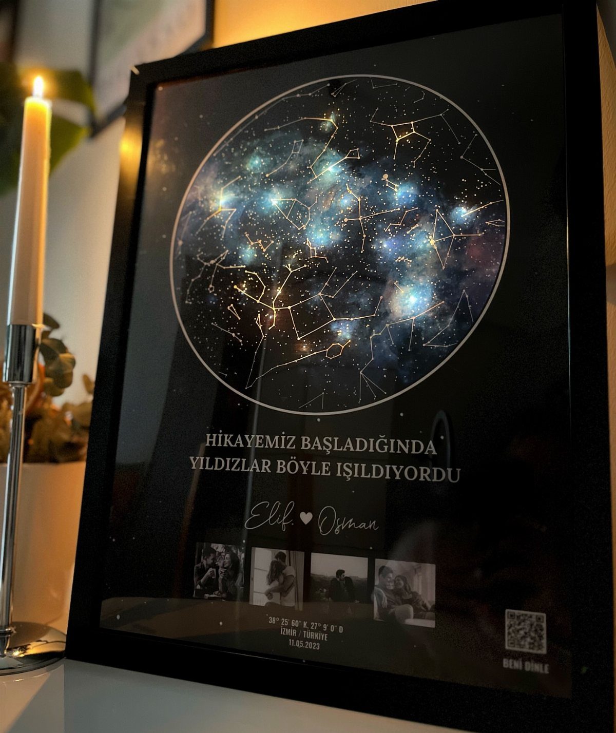 Custom star map print in a black frame with a lit candle nearby.