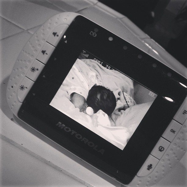 Motorola baby monitor showing a sleeping baby on its digital screen