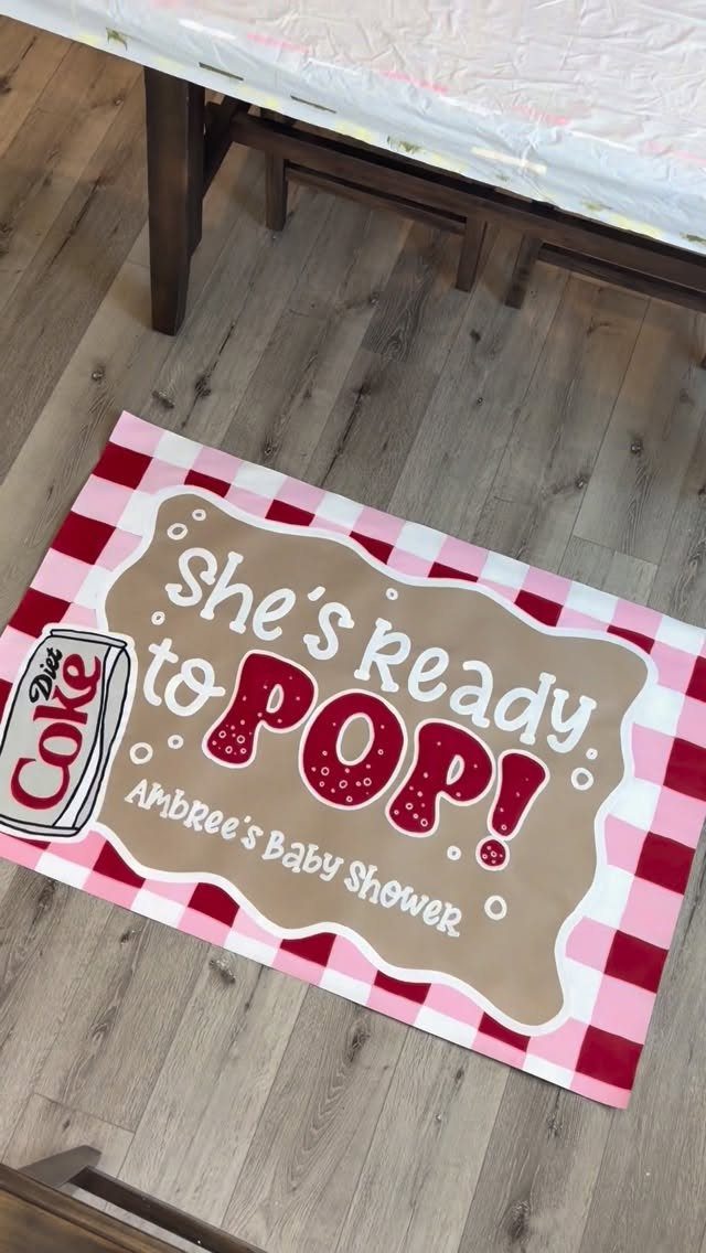 Custom baby shower mat with red checkered border and She's Ready to Pop text