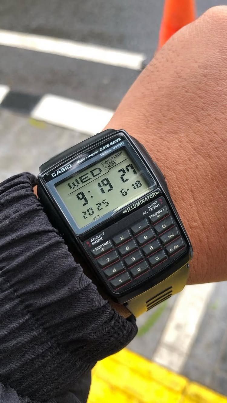 Casio calculator watch with digital display worn on a person's wrist