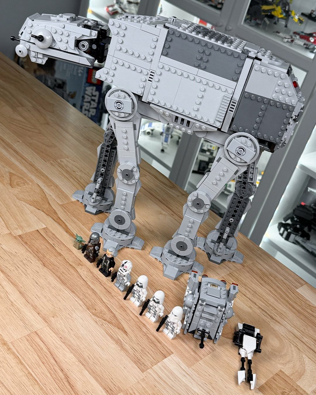 LEGO Star Wars AT-AT walker and minifigures on a light wooden table