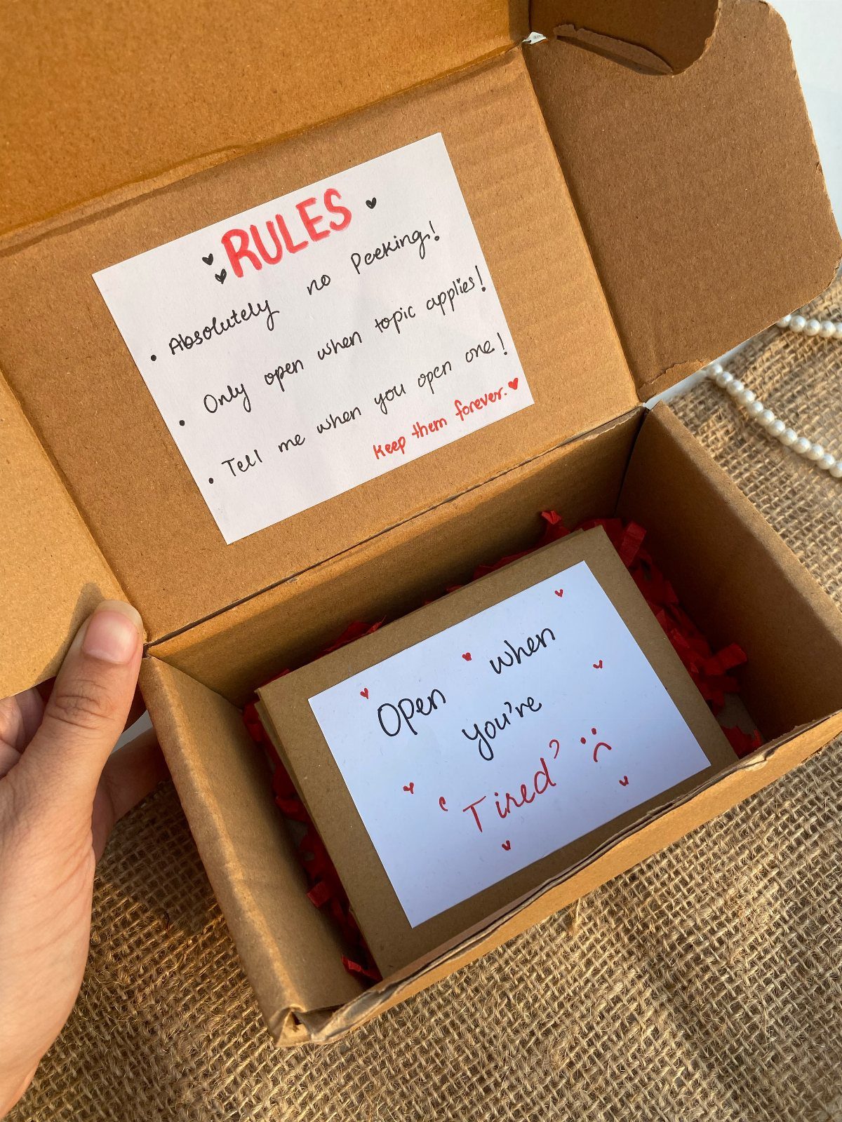 Hand-made open when gift box with handwritten rules and themed envelopes