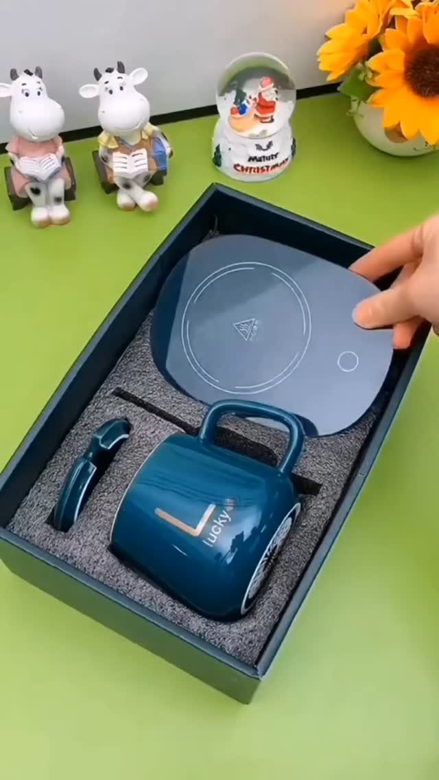 Blue mug and heating pad gift set inside a dark blue presentation box