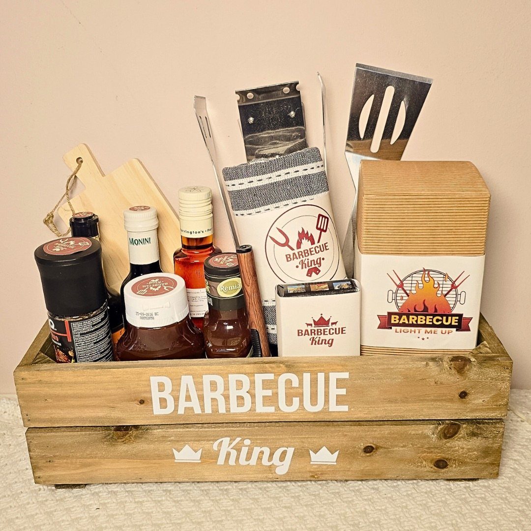 Wooden BBQ caddy filled with sauces, spices, and grilling tools for a barbecue king.