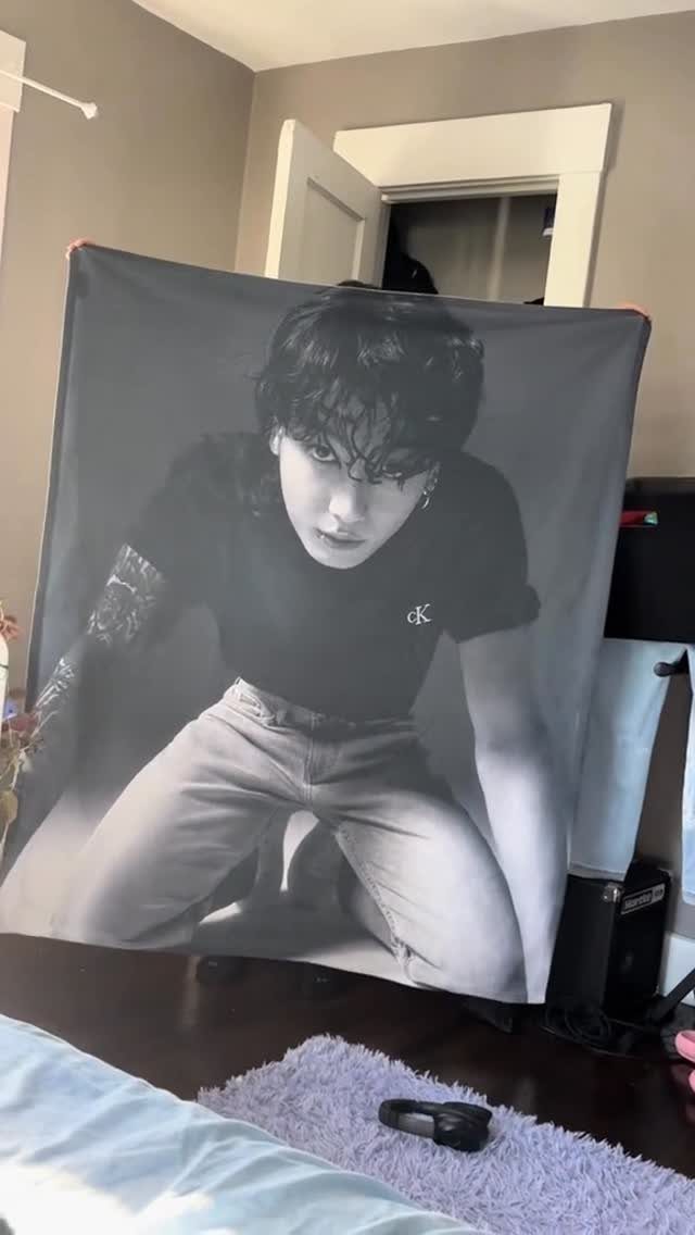 Black and white celebrity tapestry hanging in a bedroom as a teen gift.