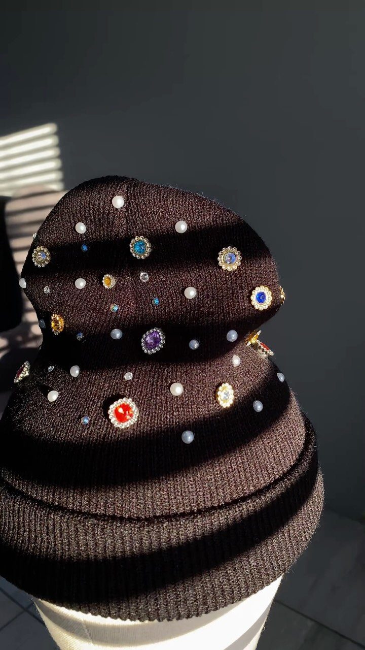 Black knit beanie embellished with colorful sparkling gemstones and crystals.