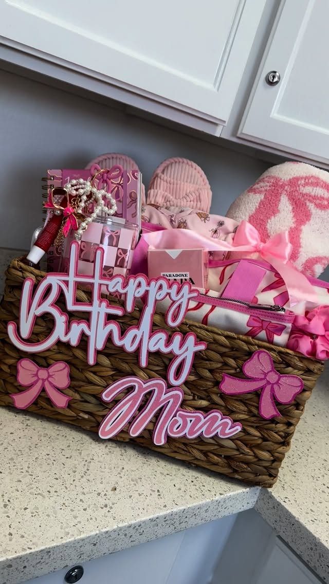 Woven gift basket filled with pink items and a Happy Birthday Mom sign.
