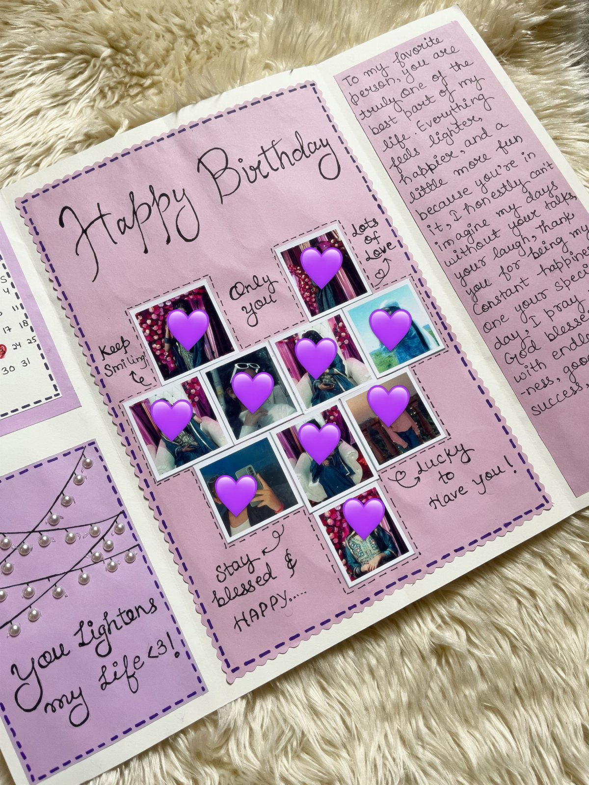 Handmade purple birthday card with photos, heart stickers, and handwritten messages on fluffy white fabric