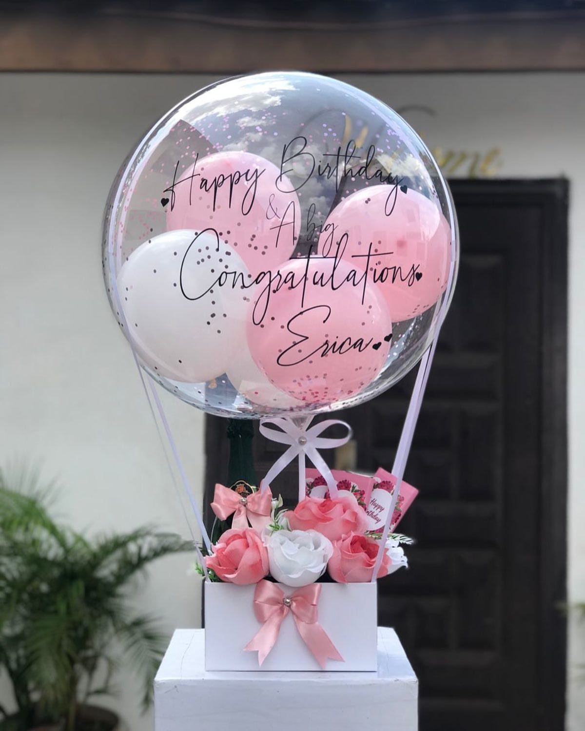 Birthday balloon arrangement with pink and white roses in a white gift box.