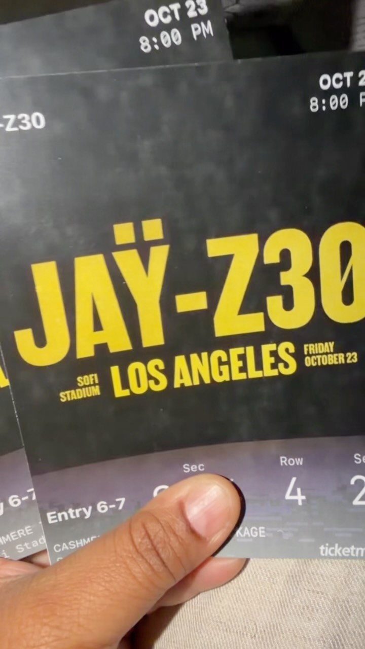 Concert tickets for Jay-Z at SoFi Stadium held by a person's hand.