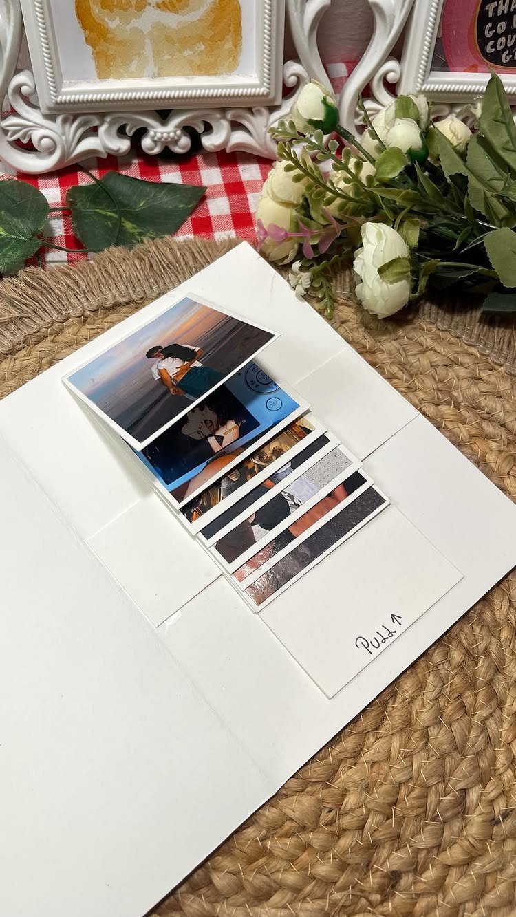 Handmade white card with a pull-tab revealing a sequence of couple photographs.