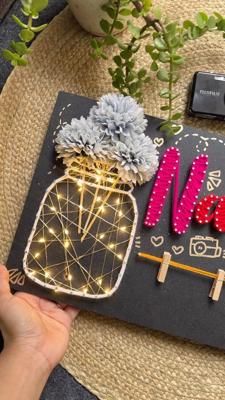 Handmade 3D card with a light-up jar, paper flowers, and pink lettering.