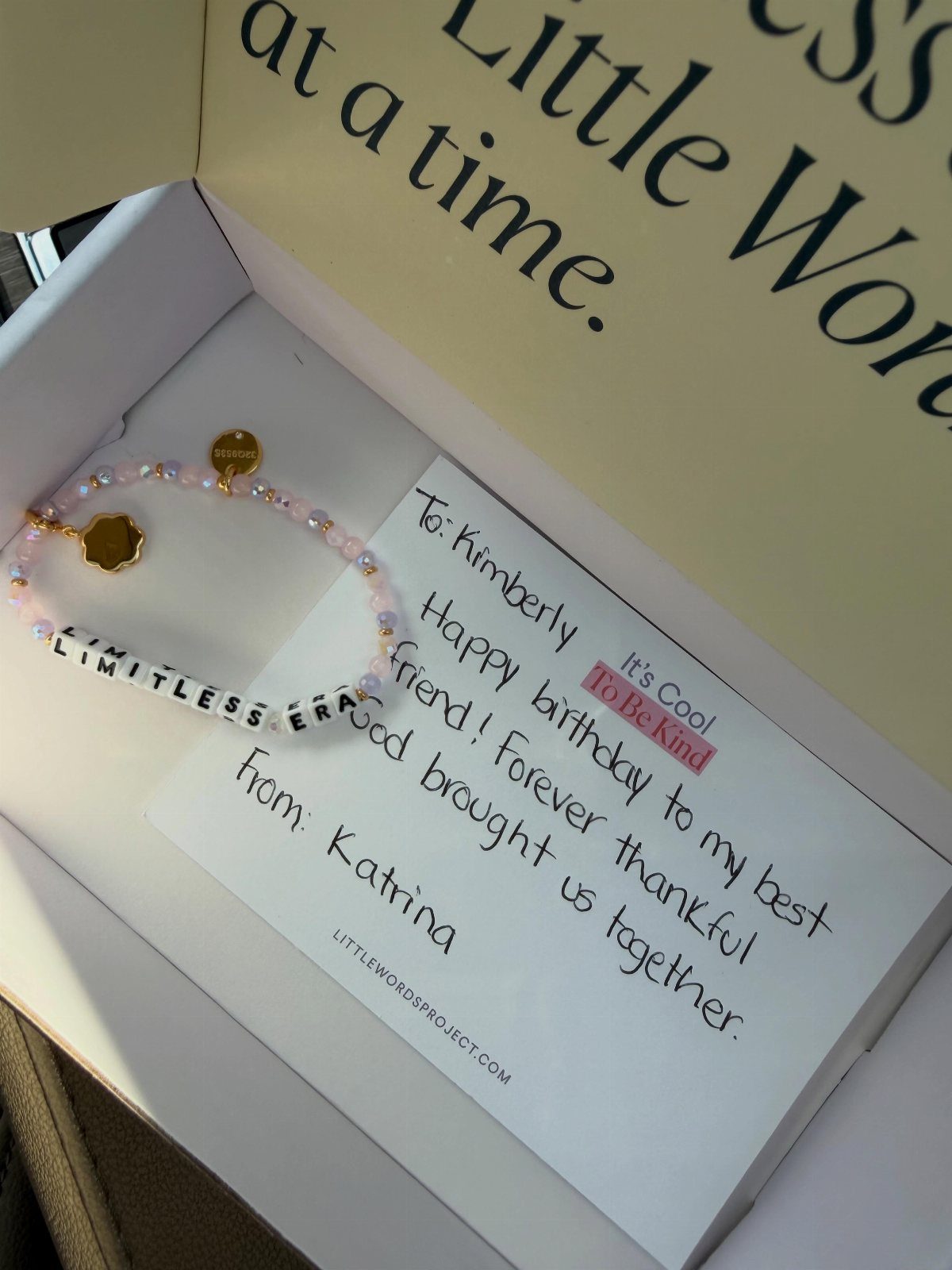 Beaded friendship bracelet with LIMITLESS ERA text and a handwritten birthday note.