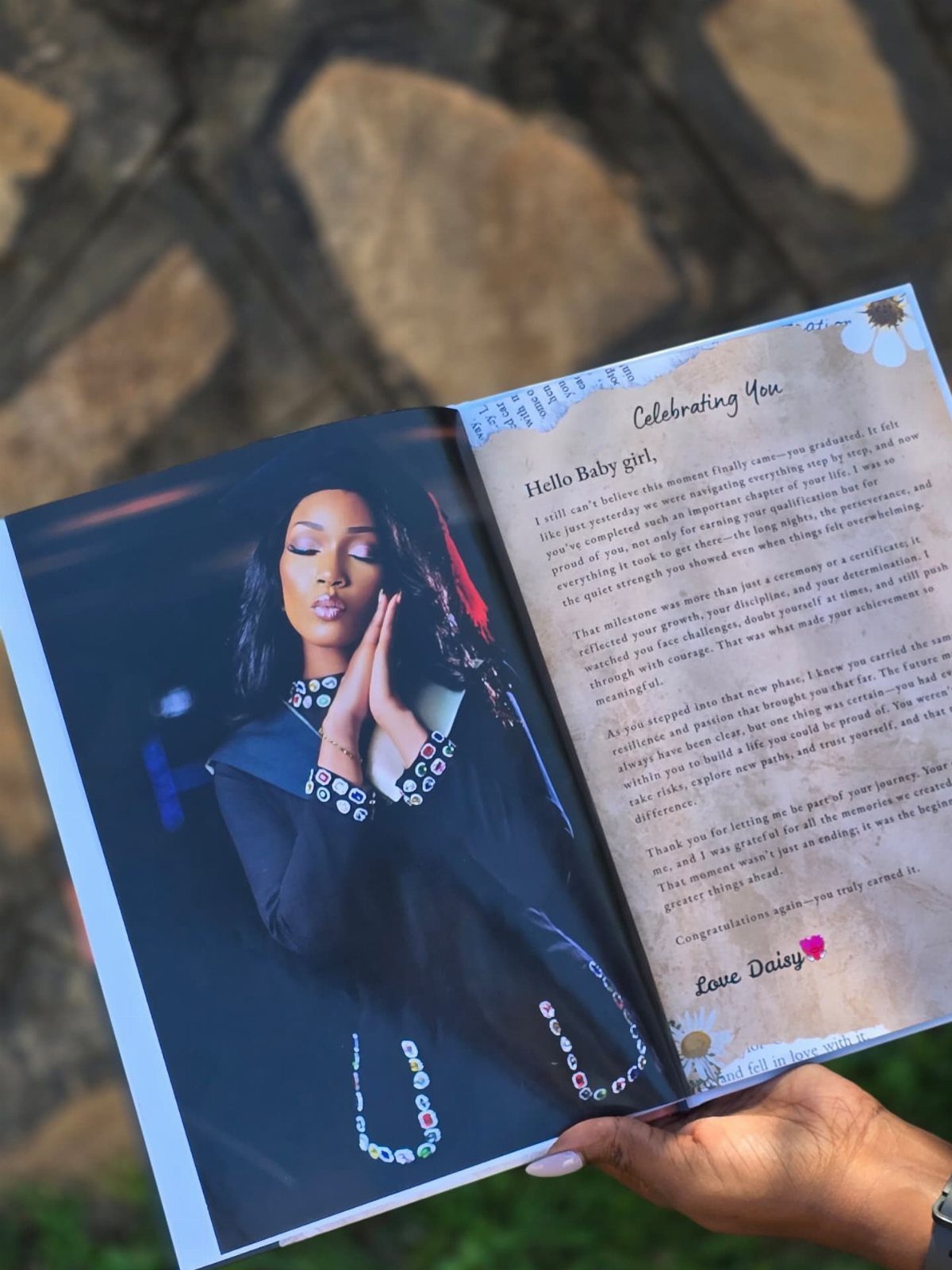 Open personalized photo book with a woman's portrait and a heartfelt letter.