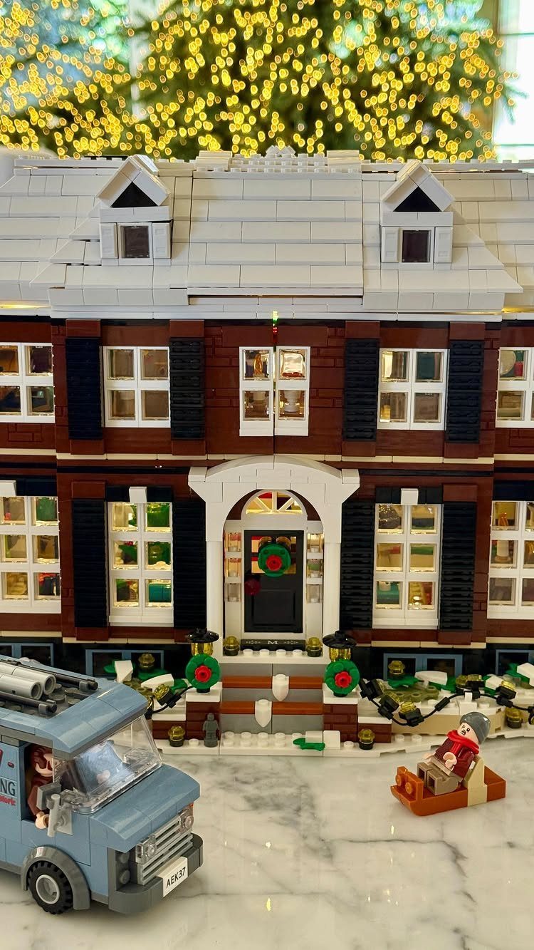 LEGO house model with snow on roof and a blue van in front