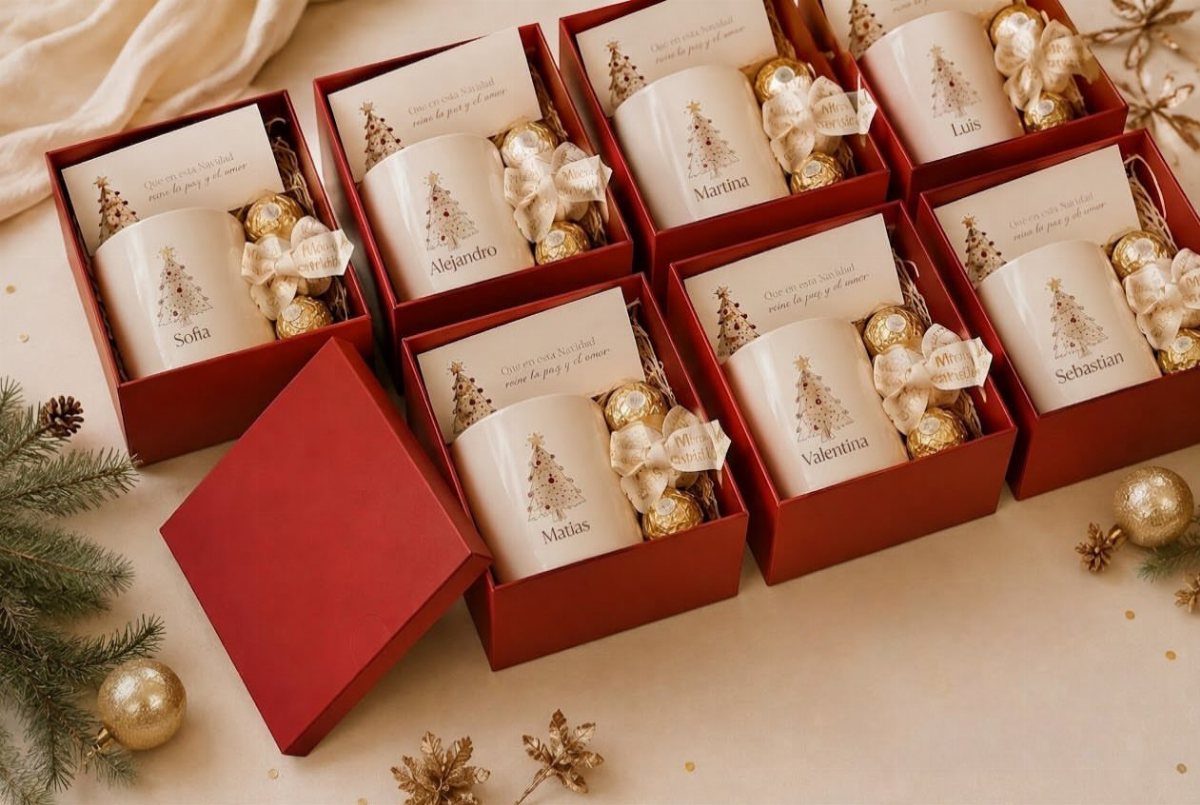 Personalized white mugs with gold Christmas trees in red gift boxes with chocolates.