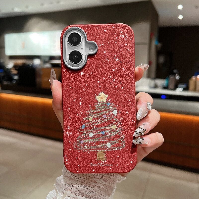 Red textured phone case with a glittery Christmas tree held by manicured hand