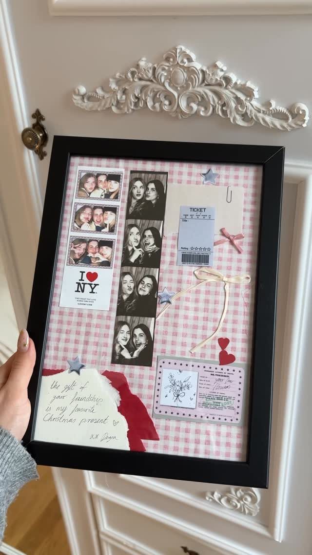 Framed shadow box gift with photos, a ticket, and a handwritten Christmas note.