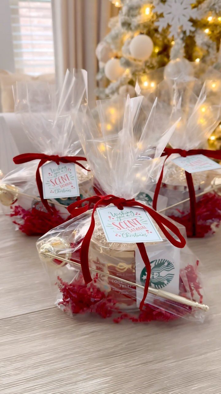 Christmas gift bags with Starbucks cards and candles tied with red ribbons