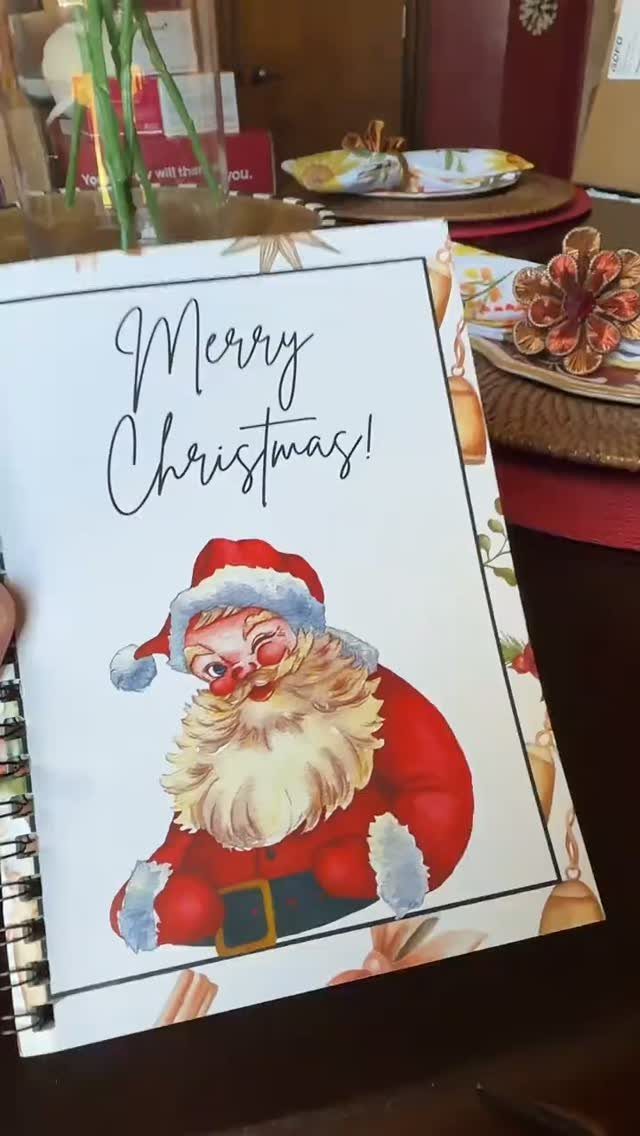 Spiral notebook with Santa Claus illustration and Merry Christmas text on the cover.