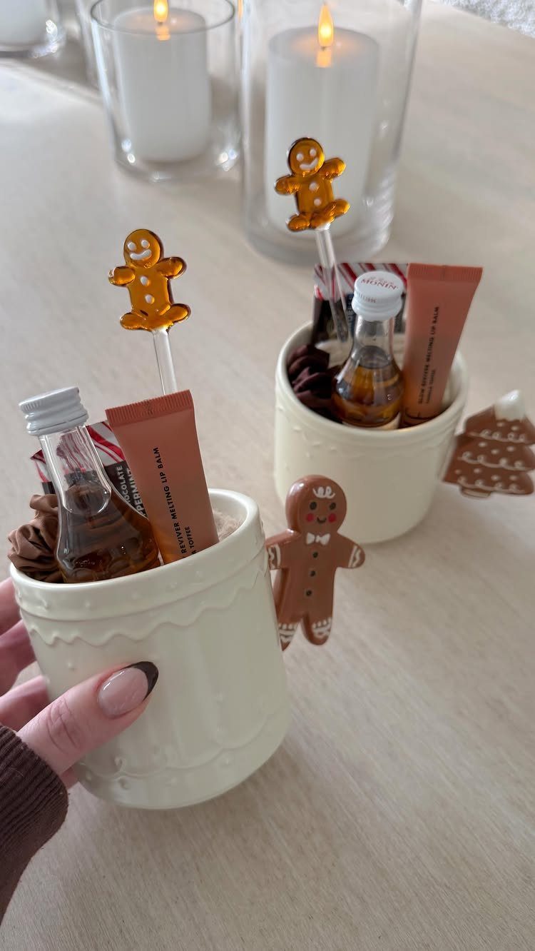 Small white ceramic gift pots filled with treats and gingerbread man decorations.
