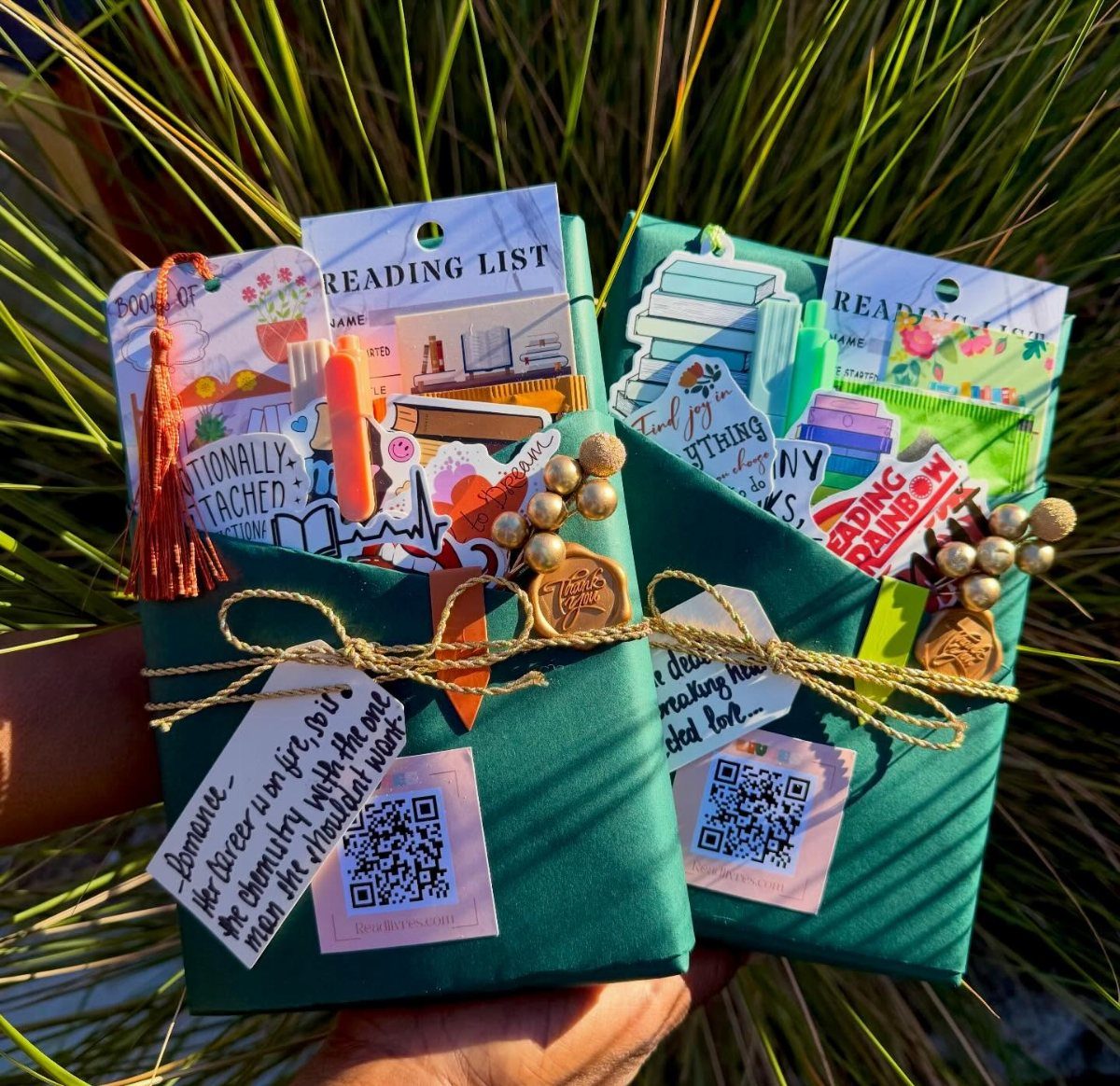Two green envelopes filled with colorful reading lists and handmade paper crafts.