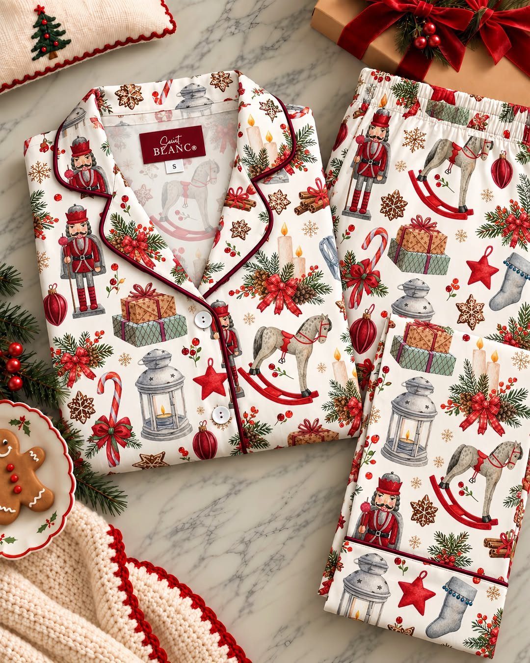 Christmas themed pajama set with nutcrackers and rocking horses on marble surface