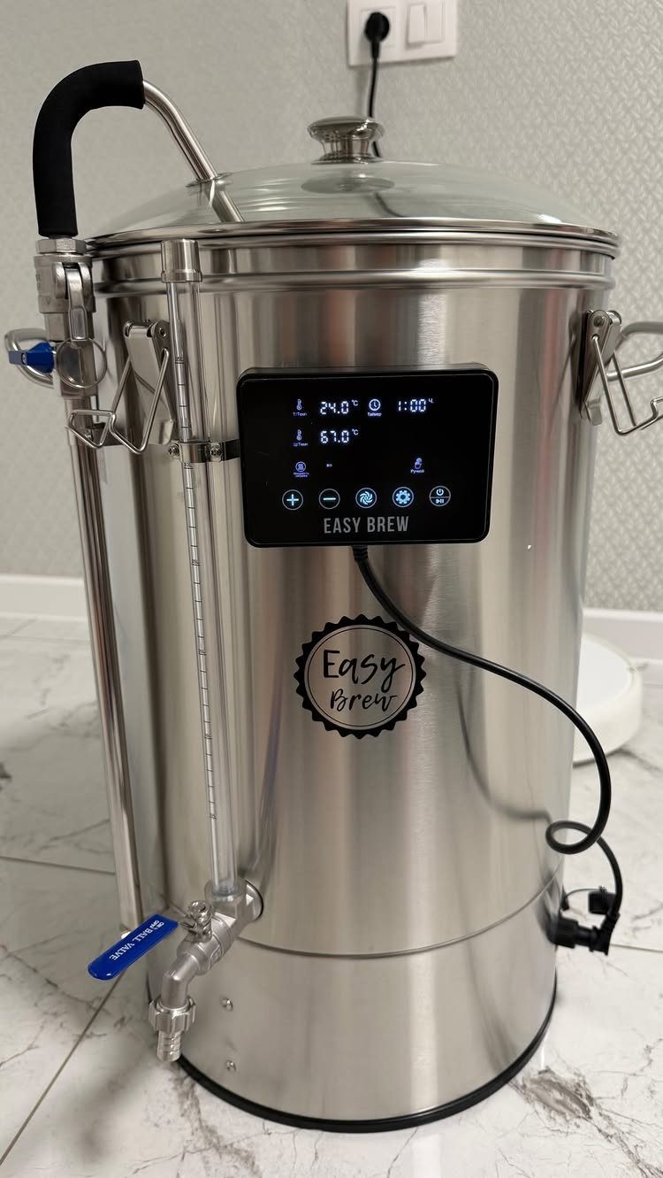Stainless steel electric beer brewing system with digital display and bottom tap.