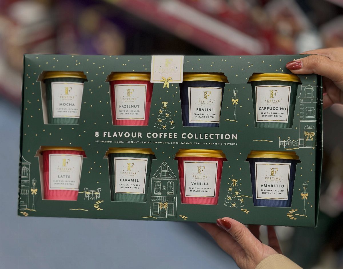 Coffee gift set box with eight flavored coffee containers held by two hands.