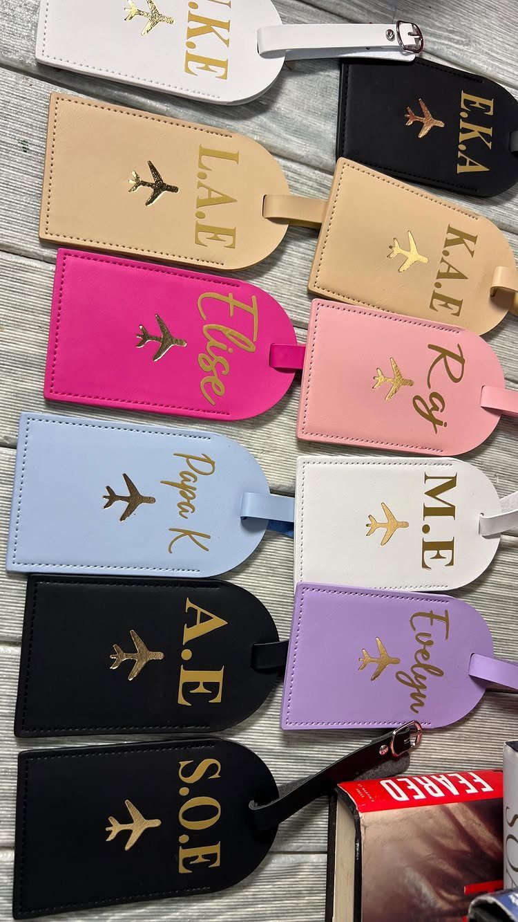 Colorful leather luggage tags with gold foil airplane icons and personalized names.