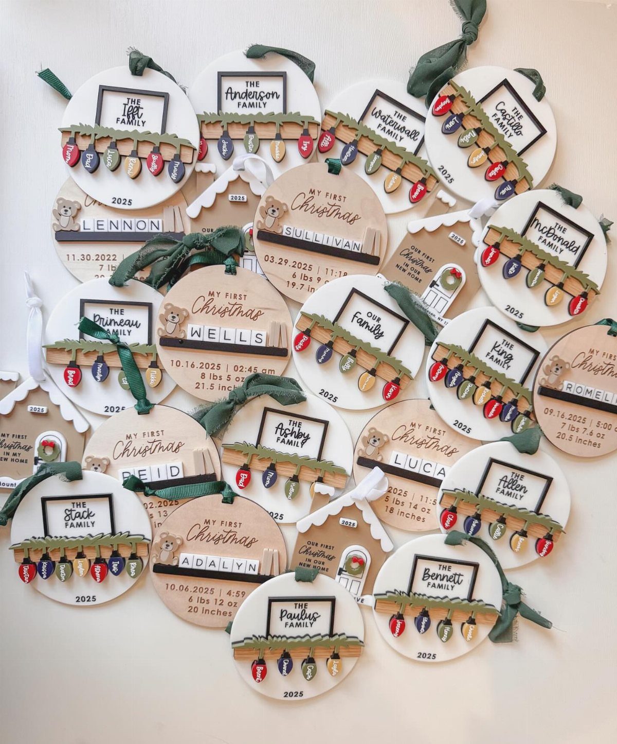 Personalized wooden Christmas ornaments with family names and miniature colorful holiday lights.