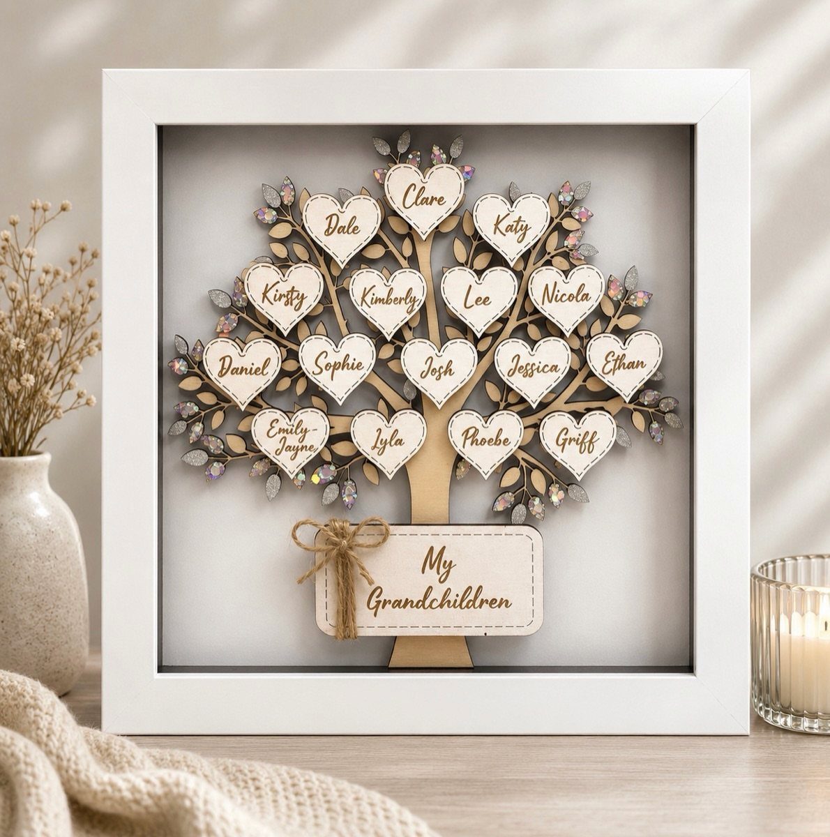 Wooden family tree art in a white shadow box with named heart plaques