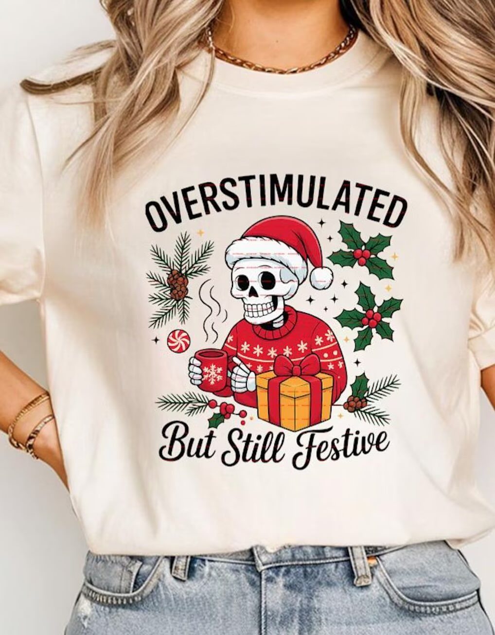 Woman wearing a cream t-shirt with a festive skeleton graphic and holiday text