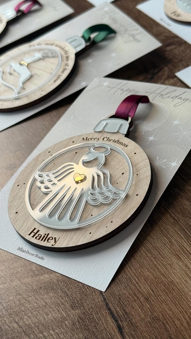 Personalized wooden angel Christmas ornament with the name Hailey on a white card.