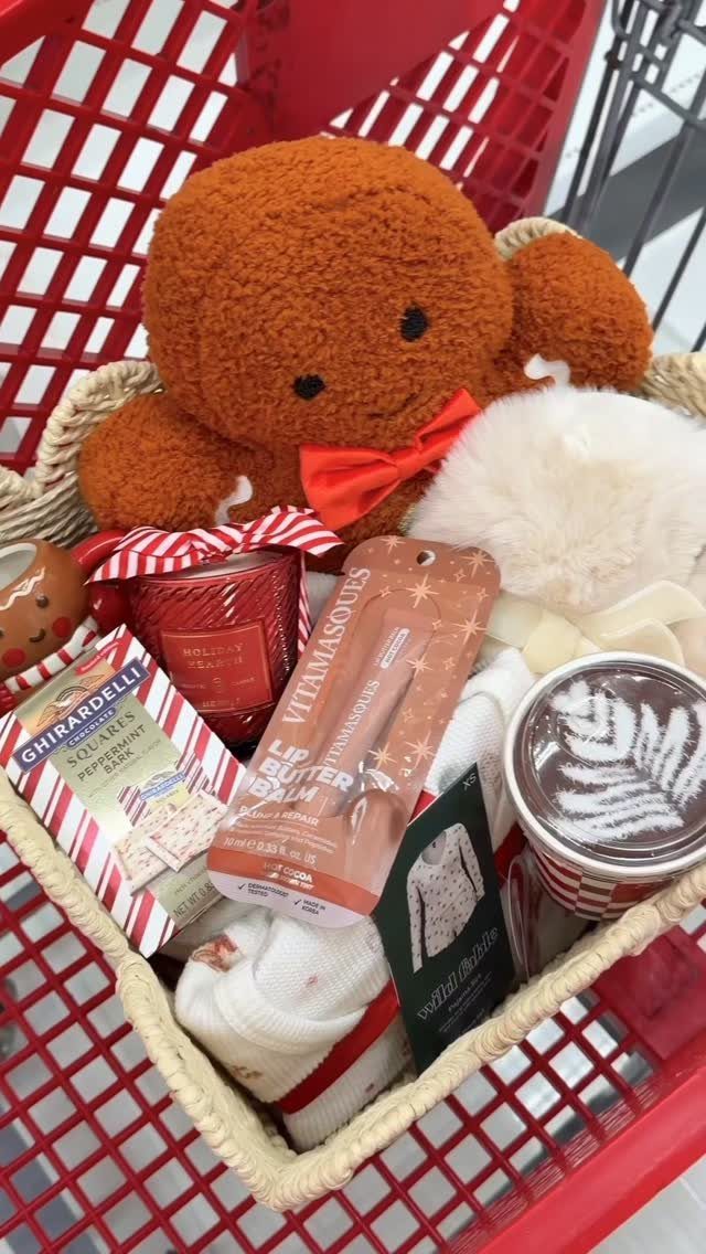 Gift basket with teddy bear, chocolates, and bath products in a red cart