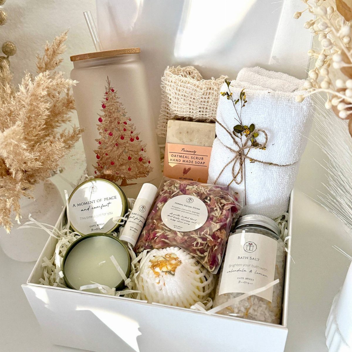 Spa gift set in a white box with bath salts, candle, and towel.