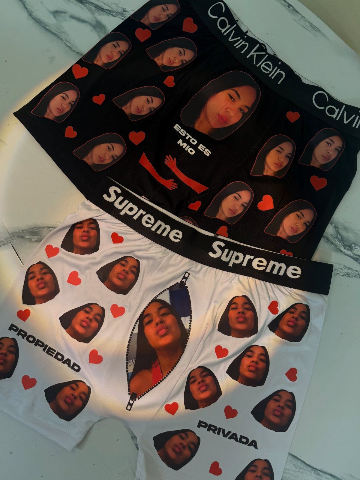 Custom boxer briefs with a repeating pattern of a woman's face and red hearts.