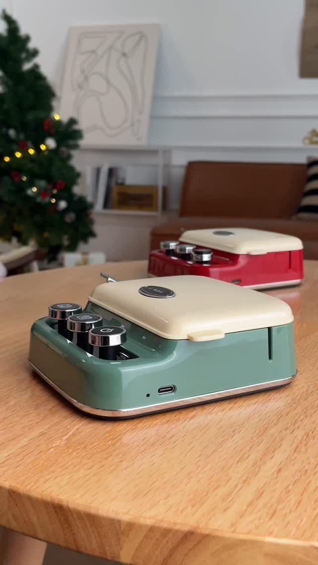 Sage green retro electric grill on a wooden table with Christmas tree background