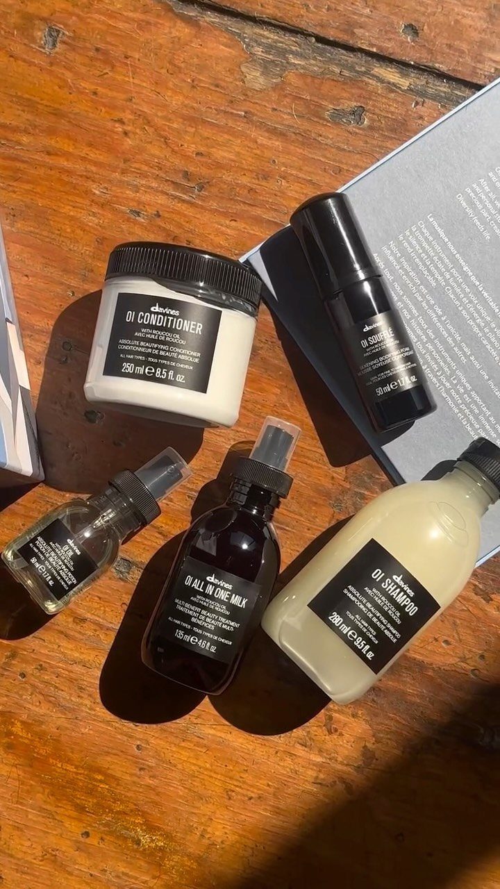 Hair care product set with shampoo and conditioner on a wooden table.