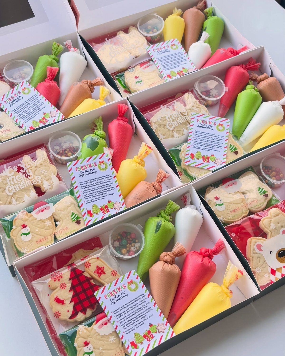 Cookie decorating kits in white boxes with colorful icing and festive sprinkles.