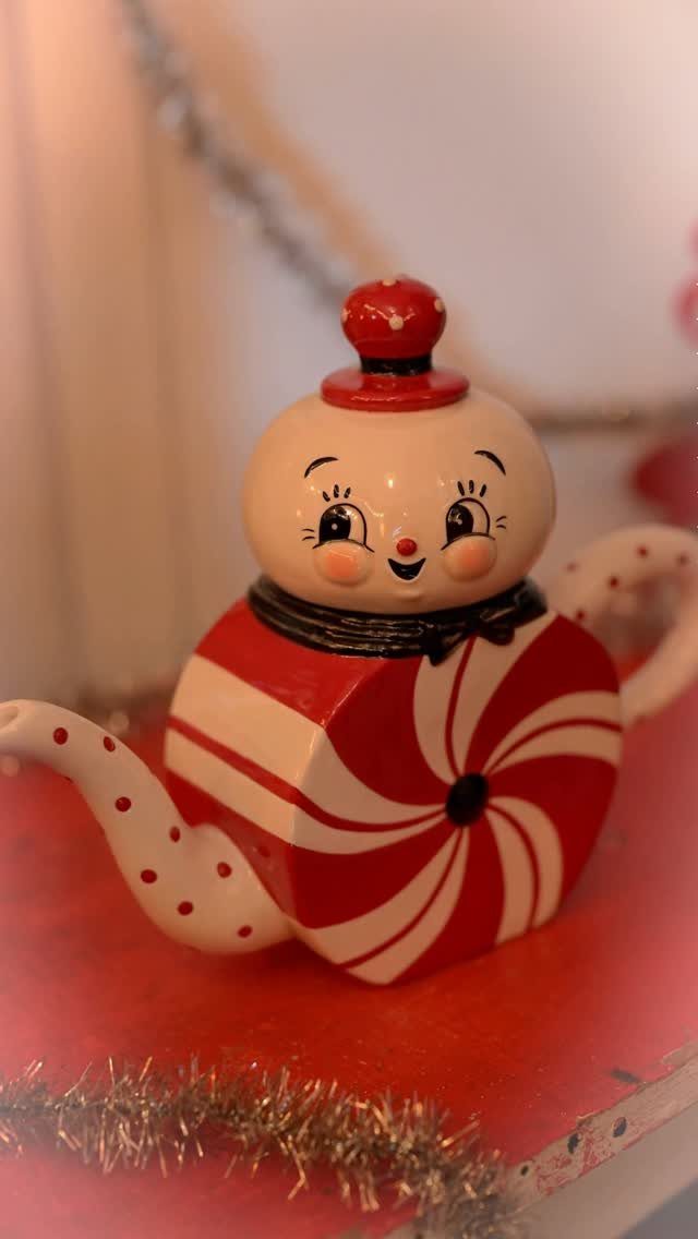 Snowman shaped ceramic teapot with red and white peppermint stripes and polka dots.
