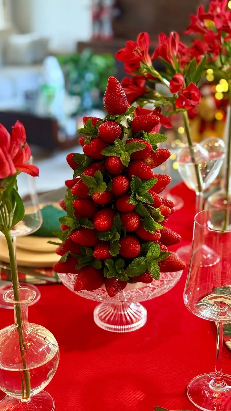 Strawberry tower arranged as a tree on a red Christmas table setting.
