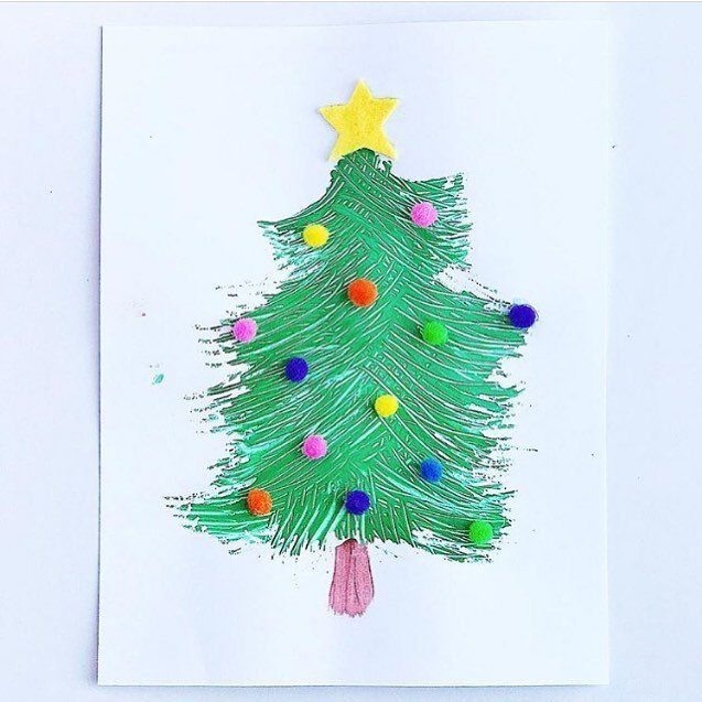 Fork painted green Christmas tree decorated with colorful pom-poms and a yellow star.